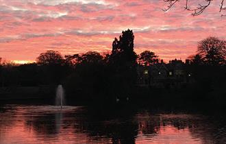 A romantic pink and red sky above Bletchley Park's Mansion