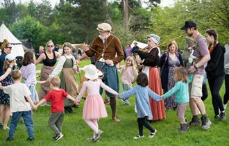 Families enjoying Elizabethan music and dancing during May Day Merriment at Chiltern Open Air Museum