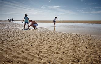 Children playing at low tide on Camber Sands