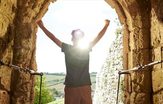 Child looking out from Carisbrooke Castle, May Half Term event, what's on, Isle of Wight