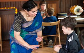 Lady in a saree talking to child