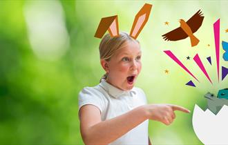 There is a girl wearing a white t-shirt and she has animated bunny ears on her head. She is pointing at an animated egg that has a snake, frog, butter
