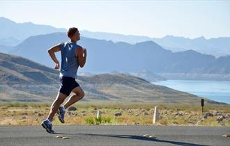 Person running on a scenic road