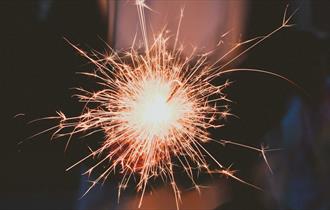 Person holding white sparkler