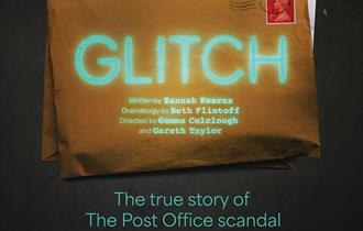 A brown envelope with the word Glitch emblazoned across the front. A Reading postal stamp is on top of the stamp.