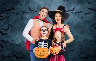 Family dressed in costume for Halloween.