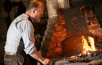 Blacksmith working in a Victorian forge