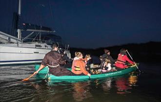A family paddling along the Beaulieu River on New Forest Activities Spooky Halloween River Tour