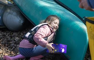 A young girl searching for easter eggs on New Forest Activities Canoe Easter Egg Hunt