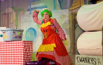 Cast member dressed in Dame costume