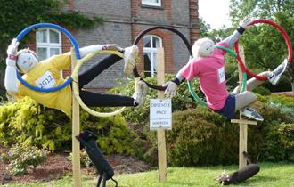 Scarecrows in Olympic hoops at Battle Scarecrow Festival