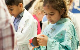 Girl doing a craft activity with paper and colours