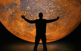 A person stands under mars
