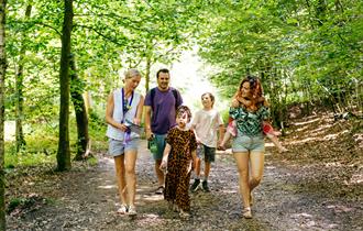 Family walking in leafy woods