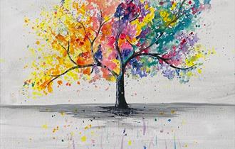 Painting of a tree in rainbow colours with splatters on a plainbackground