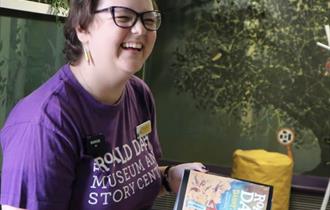 Woman holding a book and smiling