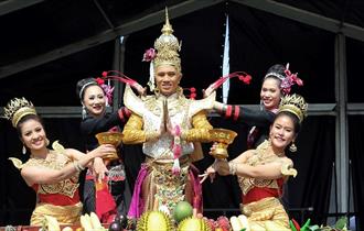 Five people in traditional dress performing at the Southsea Thai Food and Craft Festival