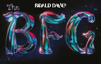 Against a black background, text reads 'Roald Dahl's The BFG'. 'Roald Dahl' is in white, with 'The BFG' in a magical, shimmering type with pink, purpl