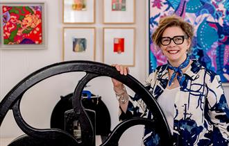 Tori McLean standing by her Rochet etching press at Studio 21