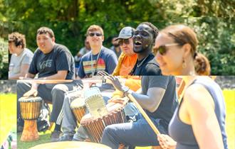 smiling people playing drums