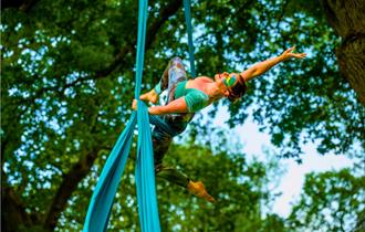 acrobat performing on an aerial silk