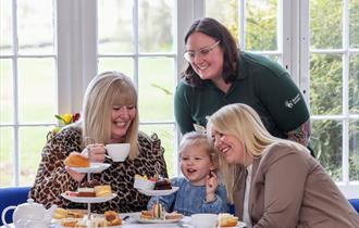 Family eating afternoon tea at Marwell Zoo