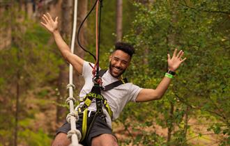 Man on zipline at Go Ape Crawley