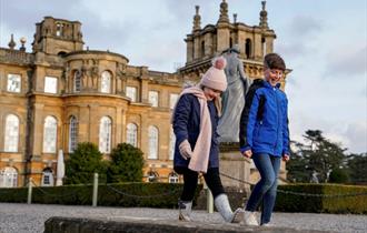 Two children walking in front of Blenheim Palace