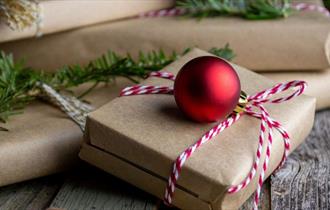 Presents and baubles on a wooden table, Christmas Fair at Northwood House, Isle of Wight, event, what's on, family fun, children activities, dog frien