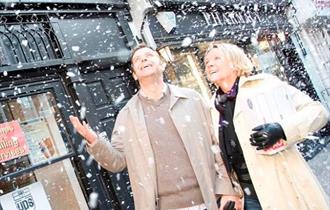 Couple in marlow high street with 'snow effect'.