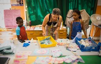 Children and an adult being creative with crafts