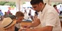 Chris Bevin helping children cook in the Little Chefs Den at at The Great Wight Bite, food and drink festival, Cowes, Isle of Wight, event, what's on