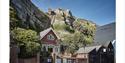 photograph of the east hill from the lower station. Shows brick building at the bottom of funicular railway cut into cliff.