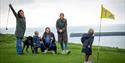 Family playing golf overlooking Folkestone Harbour Arm