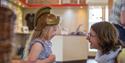 Child dressing up at Fishbourne Roman Palace
