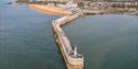 View over Folkestone harbour arm with town in the distance