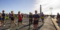 People taking part in the Great South Run, going past the War Memorial on Southsea Seafront