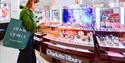 Lady shopping at Charlotte Tilbury stand in John Lewis Oxford