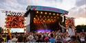 Crowds watching a band on the main stage at the Isle of Wight Festival, music event, what's on