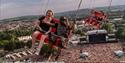 People riding the high swing ride over the crowds at the Isle of Wight Festival, music event, what's on