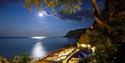 Night time view with a bright moon overlooking the Fisherman's Cottage at Shanklln beach, Things to Do, Isle of Wight