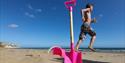 Boy next to bucket and spade on Yaverland Beach, Sandown, Isle of Wight, Things to Do