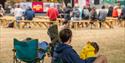 A man sits and watches the action from the Kitchen Stage at Southsea Food Festival