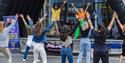 A group of people being led in a dance exercise class at the Sweat Fitness Festival