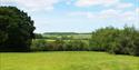 green field and rolling hills.