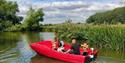 Family in a red boat on the river - Cotswold Boat Hire
