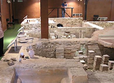 Lady viewing Roman bath at Newport Roman Villa, Isle of Wight, Things to Do