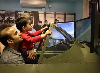 Maidenhead Heritage Centre: man and boy enjoying the Spitfire Simulator