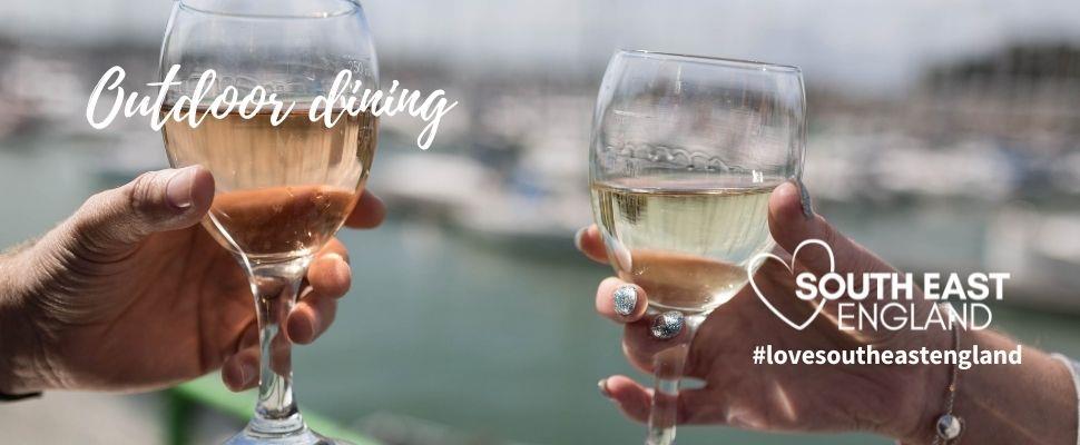 Waterfront Dining in Gosport by the Marina, glasses raised to celebrate.  Enjoy outdoor dining in Gosport, Hampshire overlooking the Solent.