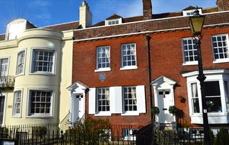 Photograph showing the exterior of the Charles Dickens' Birthplace Museum under a blue sky